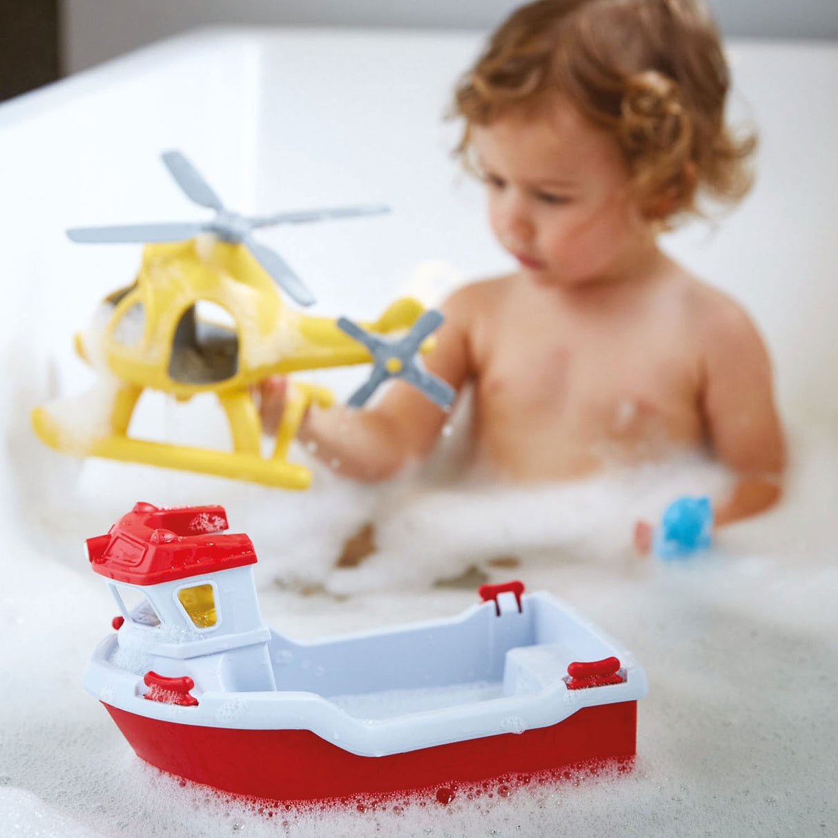 Green toys rescue boat with helicopter